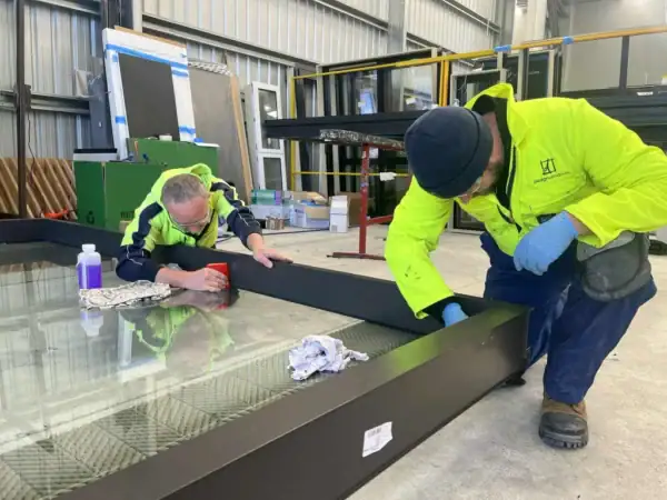 Glaziers working on windows at Design Windows West Coast