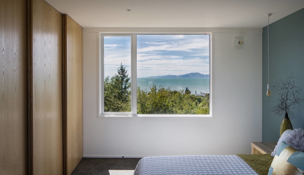 bedroom showing awing window and stacking sliding doors on wardrobe