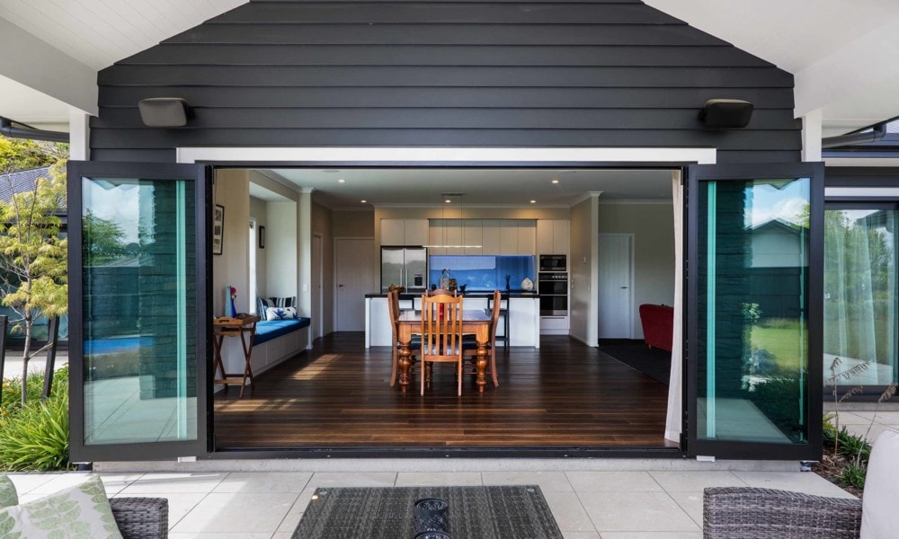 showing opened bi-fold doors from dining room onto patio