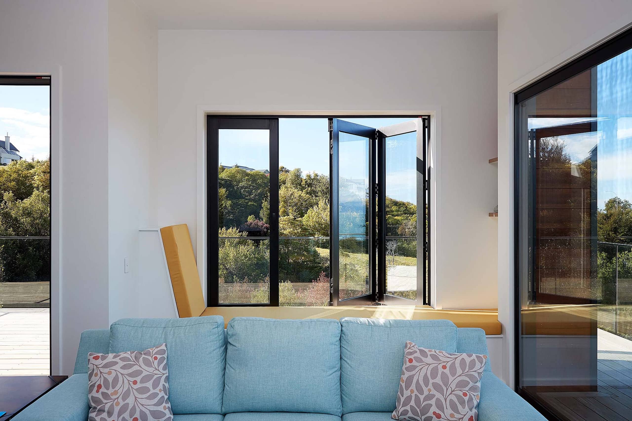 Lounge with open bi-fold aluminium windows